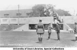Governor John Hammill receiving American flag on Iowa Field, The University of Iowa, 1925