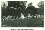 Women dressed as flowers dancing on lawn for celebration, The University of Iowa, 1920s?