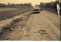 Unidentified Truck on Dirt Road with Door Open