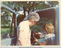 Bill supervising John, Jr. in truck driver's seat 