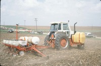 Tractor spraying in field 