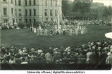 Women in costume dancing with a maypole on the Pentacrest lawn, The University of Iowa, June 1924