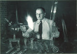 Man blowing glass for chemistry equipment, The University of Iowa, February 11, 1938
