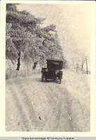 Car on road to Dubuque from Four Mounds