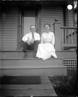 UP432 Man and woman on porch of house number 1005