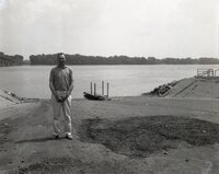 Man stands at edge of river