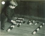 Boy playing with painted sticks, The University of Iowa, 1920s
