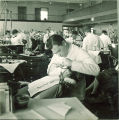 Dental student examining patient, The University of Iowa, 1940s