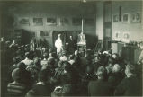 Art class watching a man painting a portrait of a model, The University of Iowa, 1930s