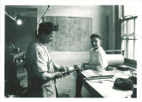 P. G. Mott constructing brace for child in Children's Hospital brace shop, The University of Iowa, May 1920