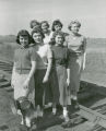 Homecoming Queen candidates standing on railroad tracks behind signal light, Homecoming, 1950