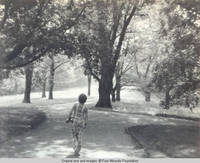 John, Jr. walks down the lane at intersection with service lane by Grey house