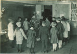 School children around Christmas tree, The University of Iowa elementary school, 1920s