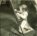 Small girl painting at an easel, The University of Iowa, January 12, 1938
