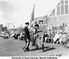 Governor's Day ceremony, cadet presenting colors to woman, The University of Iowa, 1931