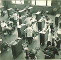 Dental students working with patients in a large clinic, The University of Iowa, 1940s