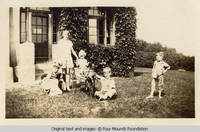 Children by Grey house front corner