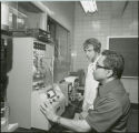 Table top equipment with two researchers, 1978