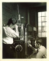 Engineering students working with mechanical device, The University of Iowa, 1940s