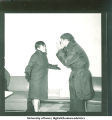 Couple in coats acting out a disagreement, 1960s
