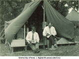 Men reading books outside tent at Camp Kellogg, The University of Iowa, 1926