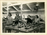 Four cadettes are holding metal model planes, 1943