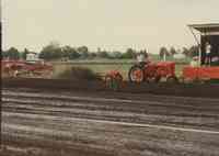 Red tractor and plow being driven at the Plymouth County Fair in July 1996.