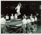 Jo Ann Juhl on a trampoline in Lucille Magnusson's gym class in Halsey Hall, The University of Iowa, 1950s