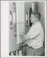 Researcher adjusts a piece of laboratory equipment.