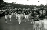 ISU football team entering the field for the Homecoming game, 1985