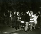 Alumni from the 1930s clapping at the pep rally on the night before Homecoming, 1969