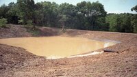 1970s Water runoff in field out of pipes