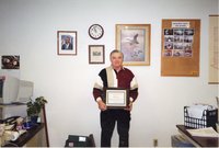2001  Marvin  Miller holds  landlord/tenant award plaque won by his Mother, Vera Miller