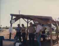 Concession Stand in Field with Five Men