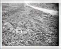 Drainage Pipe Surrounded by Enclosure in Field Next to Road