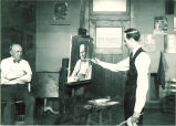 Sidney Dickinson painting a man's portrait, The University of Iowa, 1910s