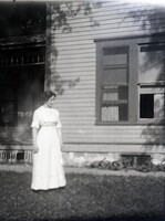 Woman by window on lawn
