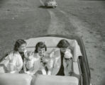 Homecoming queen and attendants waving, 1951