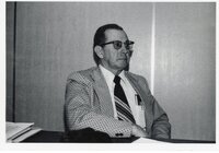 Unidentified man in suit sits at meeting