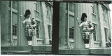 Drum major standing by Old Capitol, The University of Iowa, November 20, 1954
