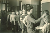 School nurse examining students, The University of Iowa elementary school, January 22, 1932