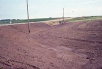 Muddy farmland by road
