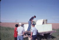 Man and people on side of field 