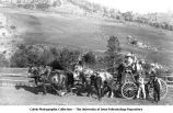 Team of four horses pulling a wagon of people toward the Gold Finch Mine, Mont., late 1890s or early 1900s