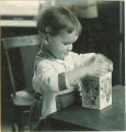 Toddler plays with nesting boxes, The University of Iowa, 1920s