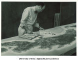 Professor Humbert Albrizio with his relief map for navy pre-flight school, The University of Iowa, 1942-43