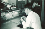 Dental student working on a model in a laboratory, The University of Iowa, 1940s