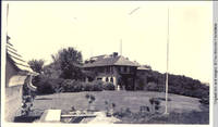 Grey house with lighting rods on roof