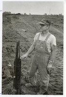 1977  Mr. Harris, a farmer, stands in field