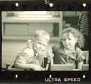 Small children sitting in wood boxes in a playroom, The University of Iowa, January 12, 1938